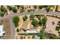 An aerial shot reveals the property's layout, featuring a pool, well-kept yard, and the surrounding neighborhood at 7102 E Kalil Dr, Scottsdale, AZ 85254