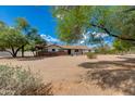 Inviting single-story residence with desert landscaping, mature trees and a well-manicured front yard at 7102 E Kalil Dr, Scottsdale, AZ 85254