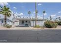 Charming single-story home with covered parking and front patio surrounded by desert landscaping at 7807 E Main St # H-27, Mesa, AZ 85207