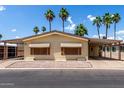 Well-maintained single-story home with a covered carport and desert landscaping at 9302 E Broadway Rd # 45, Mesa, AZ 85208