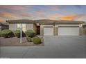 Charming single-story home featuring a three-car garage and well-manicured landscaping at 9952 W Jessie Ln, Peoria, AZ 85383