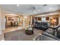 Open-concept living area with neutral paint, tile flooring, and seamless access to the kitchen and dining at 9952 W Jessie Ln, Peoria, AZ 85383