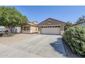 Attractive single-story home with a two-car garage and low-maintenance desert landscaping at 1026 E Julie Ave, San Tan Valley, AZ 85140