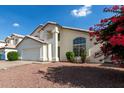 View of home's facade showcasing a driveway and partial view of the front yard at 1421 E Charleston Ave, Phoenix, AZ 85022