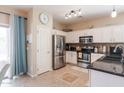Well-lit kitchen equipped with stainless steel appliances and ample cabinet space at 1461 W Brangus Way, San Tan Valley, AZ 85143