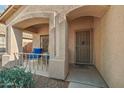 Close up view of the front porch with an outdoor seating area and shade at 15453 W Shangri La Rd, Surprise, AZ 85379