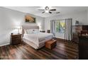 Cozy primary bedroom featuring hardwood floors, a ceiling fan and natural lighting at 16375 W Cortez St, Surprise, AZ 85388