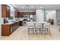 Modern kitchen with granite countertops, stainless steel appliances, and a center island with barstool seating at 16375 W Cortez St, Surprise, AZ 85388