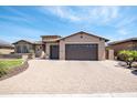 A well-kept home featuring a paved circular driveway and a spacious two-car garage at 16772 W Cypress St, Goodyear, AZ 85395