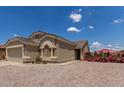 Inviting single-story home with a two-car garage, easy care landscaping, and a well-maintained facade at 1680 E Cardinal Dr, Casa Grande, AZ 85122