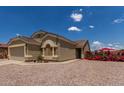 Beautiful single-story home with a well-maintained lawn, desert landscaping and a spacious two car garage at 1680 E Cardinal Dr, Casa Grande, AZ 85122