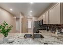 This kitchen features granite countertops, tile backsplash, stainless steel appliances, and light cabinetry at 205 N 74Th St # 166, Mesa, AZ 85207