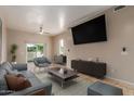 Comfortable living room with tile floors, ceiling fan, sliding glass doors, and modern furniture at 205 N 74Th St # 166, Mesa, AZ 85207
