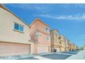 Row of townhomes featuring two-car garages, neutral color schemes and tile roofs at 2118 N 77Th Ln, Phoenix, AZ 85035
