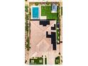 Aerial view of a private backyard with a swimming pool, green lawn, and covered patio area with solar panels at 22721 N 34Th St, Phoenix, AZ 85050
