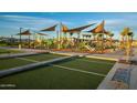 Community playground area featuring slides, shade structures, and turf, surrounded by desert landscaping at 23109 E Nightingale Rd, Queen Creek, AZ 85142