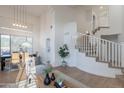 Bright open living room and dining room with soaring ceilings and large windows, creating an open space at 24433 N 75Th St, Scottsdale, AZ 85255