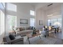 Bright living room with soaring ceilings and large windows, creating an open and airy space filled with natural light at 24433 N 75Th St, Scottsdale, AZ 85255