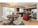 Updated kitchen next to dining area, featuring stainless appliances and a central island at 2922 S Cottonwood Dr, Tempe, AZ 85282