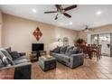 Comfortable living room with tile floors, neutral walls, ceiling fan, and a sliding glass door at 2941 N Oregon St # 12, Chandler, AZ 85225