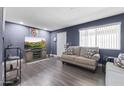 Cozy living room featuring modern paint, a comfortable couch, and contemporary flooring at 3307 W Willow Ave, Phoenix, AZ 85029
