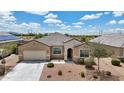 Aerial view of a single story home with a desert landscape, two car garage, and neutral color scheme at 3529 N Brooklyn Dr, Buckeye, AZ 85396