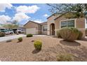 Charming single-story home with a two car garage, long driveway, and desert style landscaping at 3529 N Brooklyn Dr, Buckeye, AZ 85396