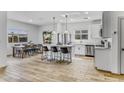 Spacious eat-in kitchen with tile flooring, stainless appliances, an island with seating, and a dining table at 40445 W Bravo Dr, Maricopa, AZ 85138