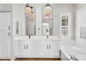 Luxurious bathroom with dual sinks, soaking tub, stylish fixtures, and ample storage at 4121 E Patrick St, Gilbert, AZ 85295