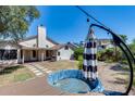Private backyard featuring a patio, grassy area, and above-ground pool with deck at 4443 W Escuda Dr, Glendale, AZ 85308