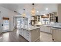 Bright open kitchen with large island, stainless steel appliances, and stylish pendant lighting at 4443 W Escuda Dr, Glendale, AZ 85308