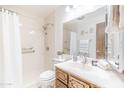 Bright bathroom with a shower, wood vanity, and decorative accents at 4501 E Carol Ave # 77, Mesa, AZ 85206