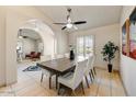 Dining room featuring tile floors, a modern table with seating for six, and a stylish ceiling fan at 5710 E Anderson Dr, Scottsdale, AZ 85254