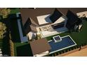 Serene aerial view of a home with a sparkling pool, outdoor seating area, and lush landscaping at 6234 S Brett Ct, Gilbert, AZ 85298