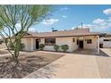 This home features low-maintenance landscaping, covered parking, and a walkway at 7049 E Latham St, Scottsdale, AZ 85257