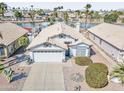 Charming single-Gathering home boasts a three-car garage and manicured front yard at 7140 E Juanita Ave, Mesa, AZ 85209
