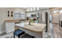 Modern kitchen featuring stainless steel appliances, granite countertops, and island seating at 7140 E Juanita Ave, Mesa, AZ 85209