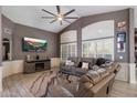 Comfortable living room boasting a ceiling fan, entertainment center with fireplace and large sectional sofa at 7925 E Osage Ave, Mesa, AZ 85212