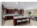 Kitchen featuring a spacious island with seating, stainless steel appliances, and modern lighting at 794 W Leatherwood Ave, Queen Creek, AZ 85140