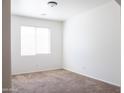 Clean bedroom featuring a window with blinds, neutral carpet, and freshly painted walls at 9025 W Crown King Rd, Tolleson, AZ 85353