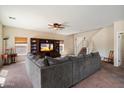Living room featuring a large sectional sofa, ceiling fan and entertainment center with a flat screen TV at 973 E Corral St, Avondale, AZ 85323