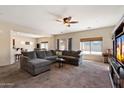 Spacious living room featuring neutral carpet, a ceiling fan, recessed lighting, and large sectional sofa at 973 E Corral St, Avondale, AZ 85323