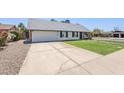 View of the home showcasing its traditional architecture and concrete driveway at 1021 S Almar Cir, Mesa, AZ 85204