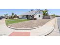 Property featuring rock landscaping and a well-maintained lawn at 1021 S Almar Cir, Mesa, AZ 85204