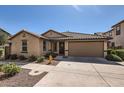 Charming single-story home with a well-maintained lawn and a two-car garage at 128 E Bluejay Dr, Chandler, AZ 85286