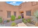 Charming front entrance with well maintained landscaping and a decorative wreath on the front door at 13450 E Via Linda -- # 2022, Scottsdale, AZ 85259