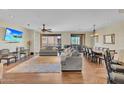 Spacious living and dining area featuring hardwood floors and comfortable seating with lots of natural light at 13450 E Via Linda -- # 2022, Scottsdale, AZ 85259