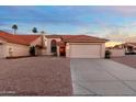 Single-Gathering home with a red tile roof, desert landscaping, and a spacious driveway leading to a garage at 14418 S 42Nd St, Phoenix, AZ 85044