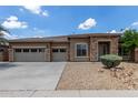 Beautiful single-Gathering home with stone accents and a spacious three-car garage on a sunny day at 15088 W Coolidge St, Goodyear, AZ 85395