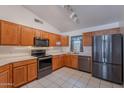 Well-lit kitchen featuring stainless steel appliances, spacious countertops, and wooden cabinetry at 17403 N 16Th Pl, Phoenix, AZ 85022